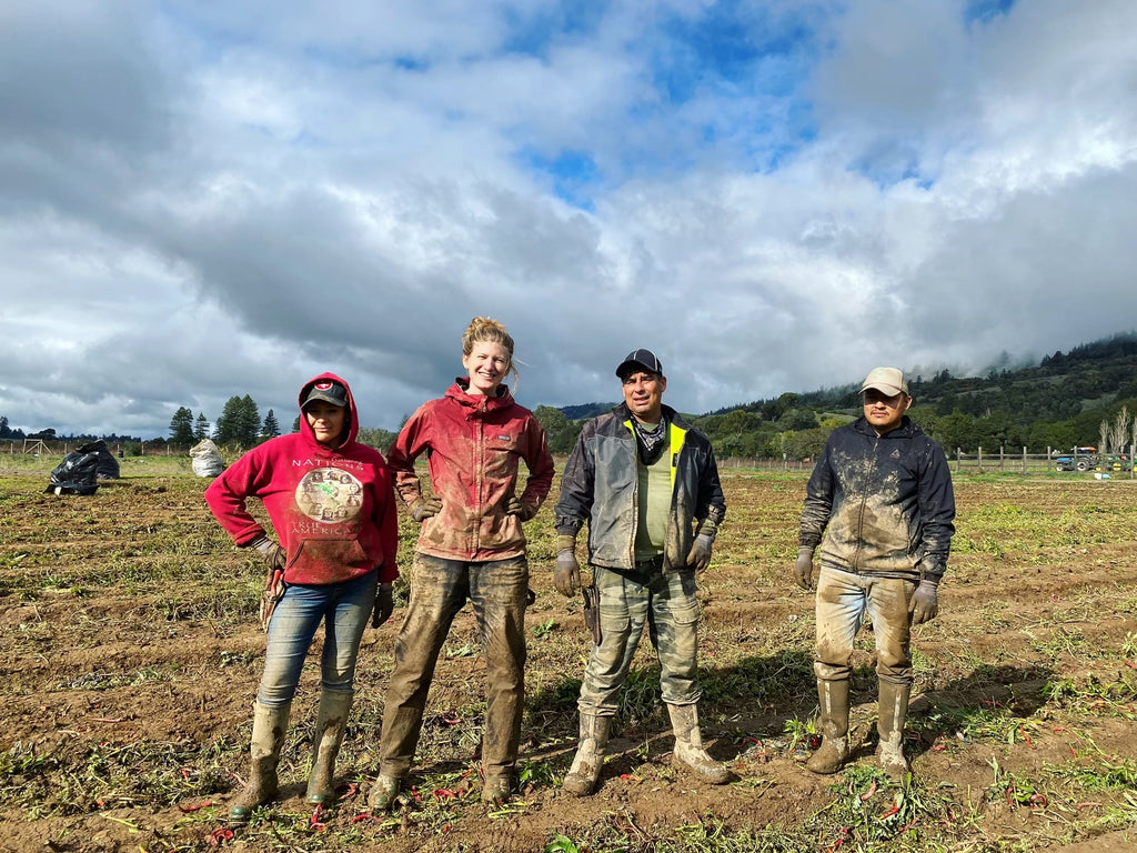 muddy people standing in field