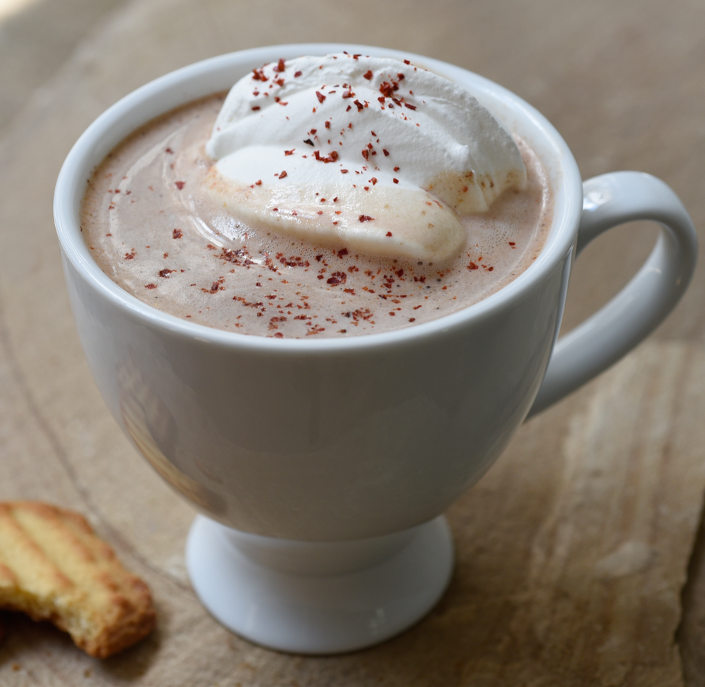 Cup of hot chocolate with whipped cream and chile