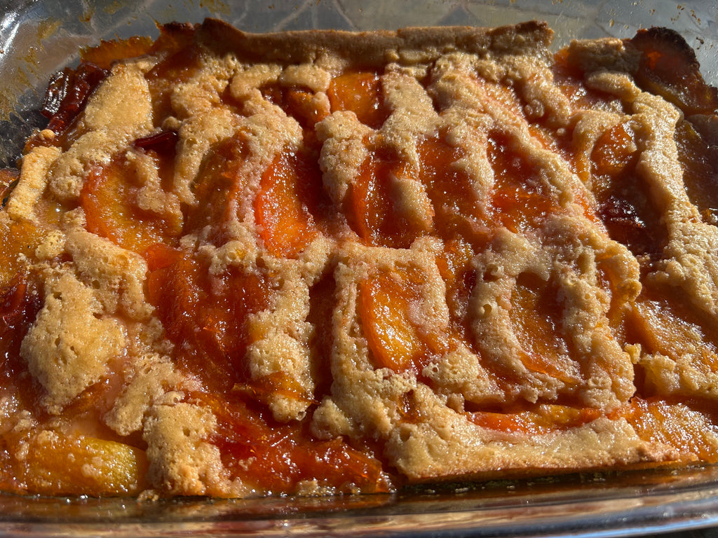 a slice of old fashioned brown sugar peach cobbler