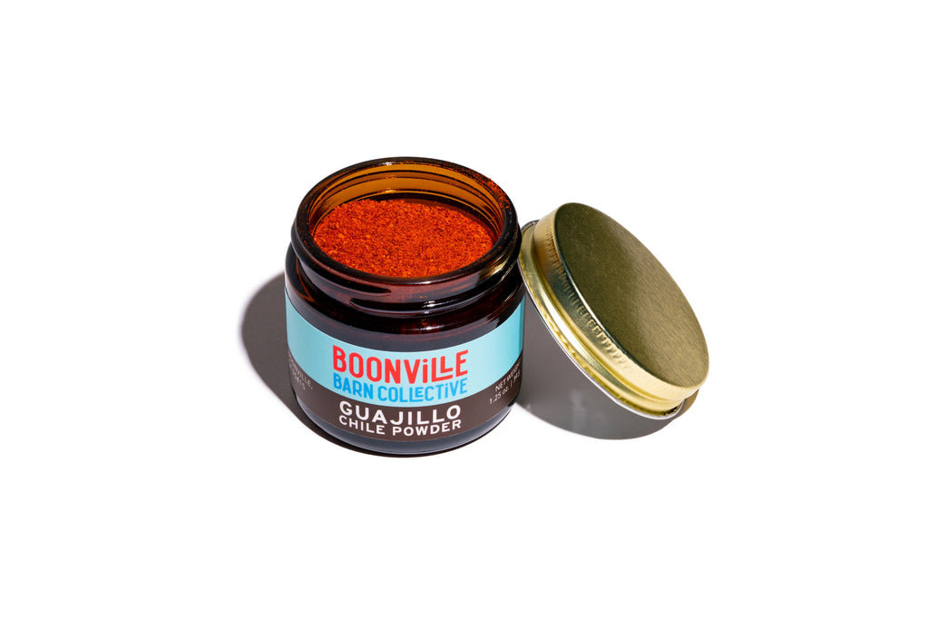 open jar of guajillo chile powder showing fine texture