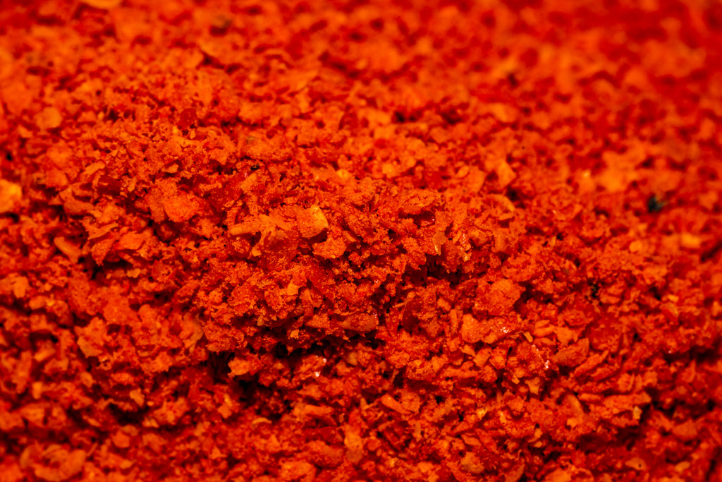 close up of orange comapeno chile powder 